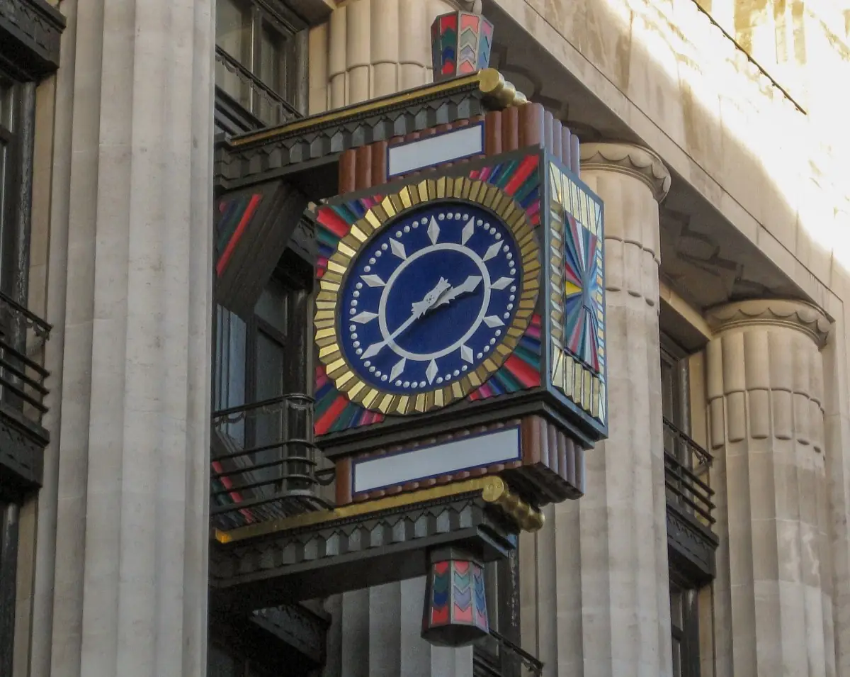 The Art Deco clock on the Peterborough Court facade, blue face with gold rays